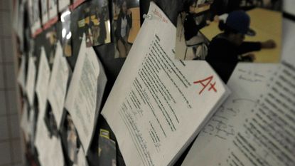 A student&rsquo;s paper is seen with an A+ grade. 