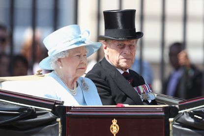 Queen Elizabeth II and Prince Philip, Duke of Edinburgh travel in the royal carriage