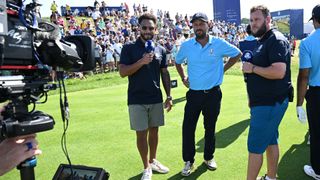 Tommaso Perrino (2R) gives an interview to TV presenters, including Andrew 'Beef' Johnston (R) on the 16th tee during the All-Star match played ahead of the 44th Ryder Cup at the Marco Simone Golf