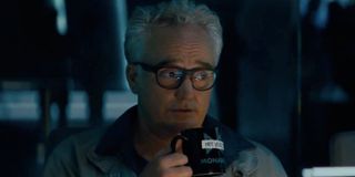 Godzilla: King of the Monsters Rick drinking coffee during a briefing