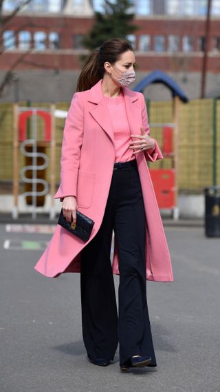 Kate Middleton in a pink coat and wide leg trousers