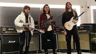 Polyphia standing in front of Marshall amps