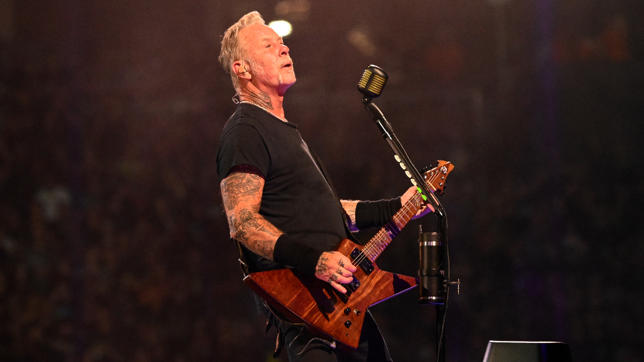 James Hetfield on stage looking up into the difference