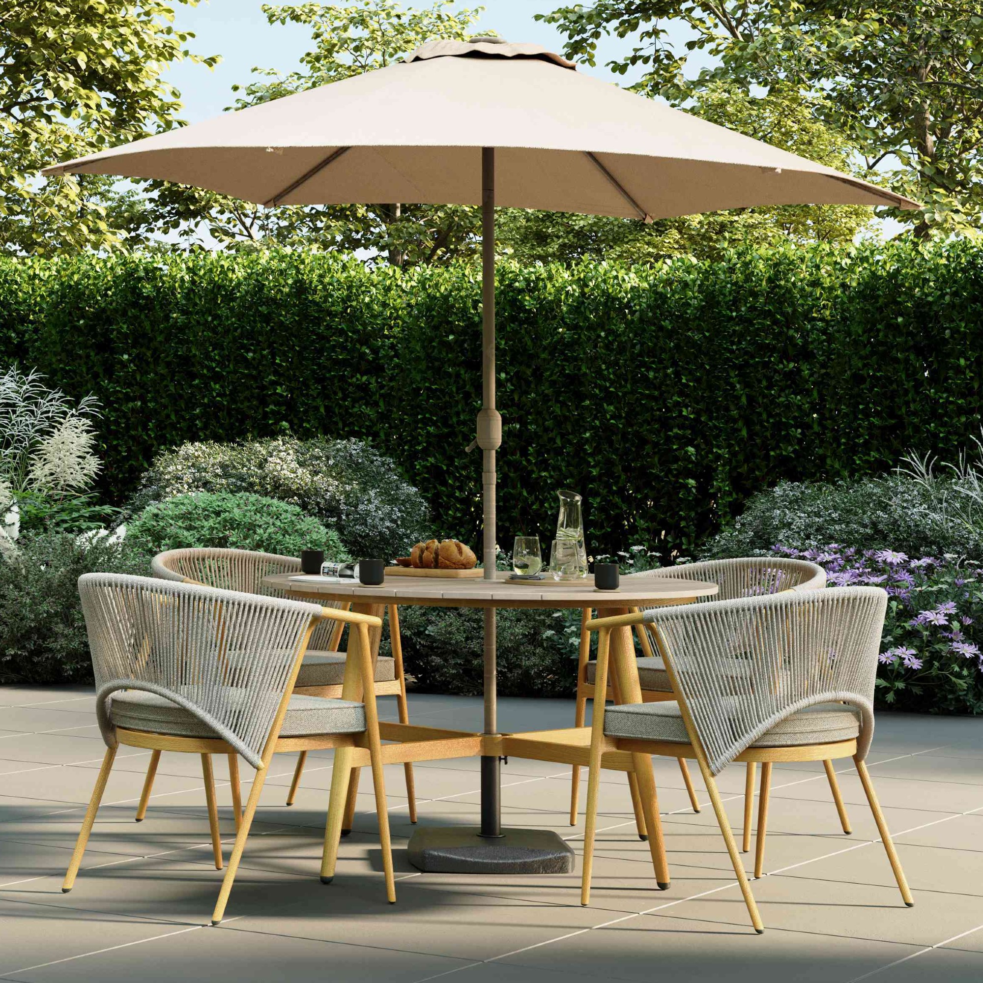 Charles Bentley's Almada 4 Seater Dining Set with a parasol on a sunny patio