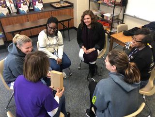 Participants sit in a circle as they engage in a character-building workshop.