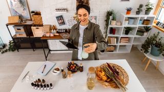 A lady mixing essential oils to make a perfume blend