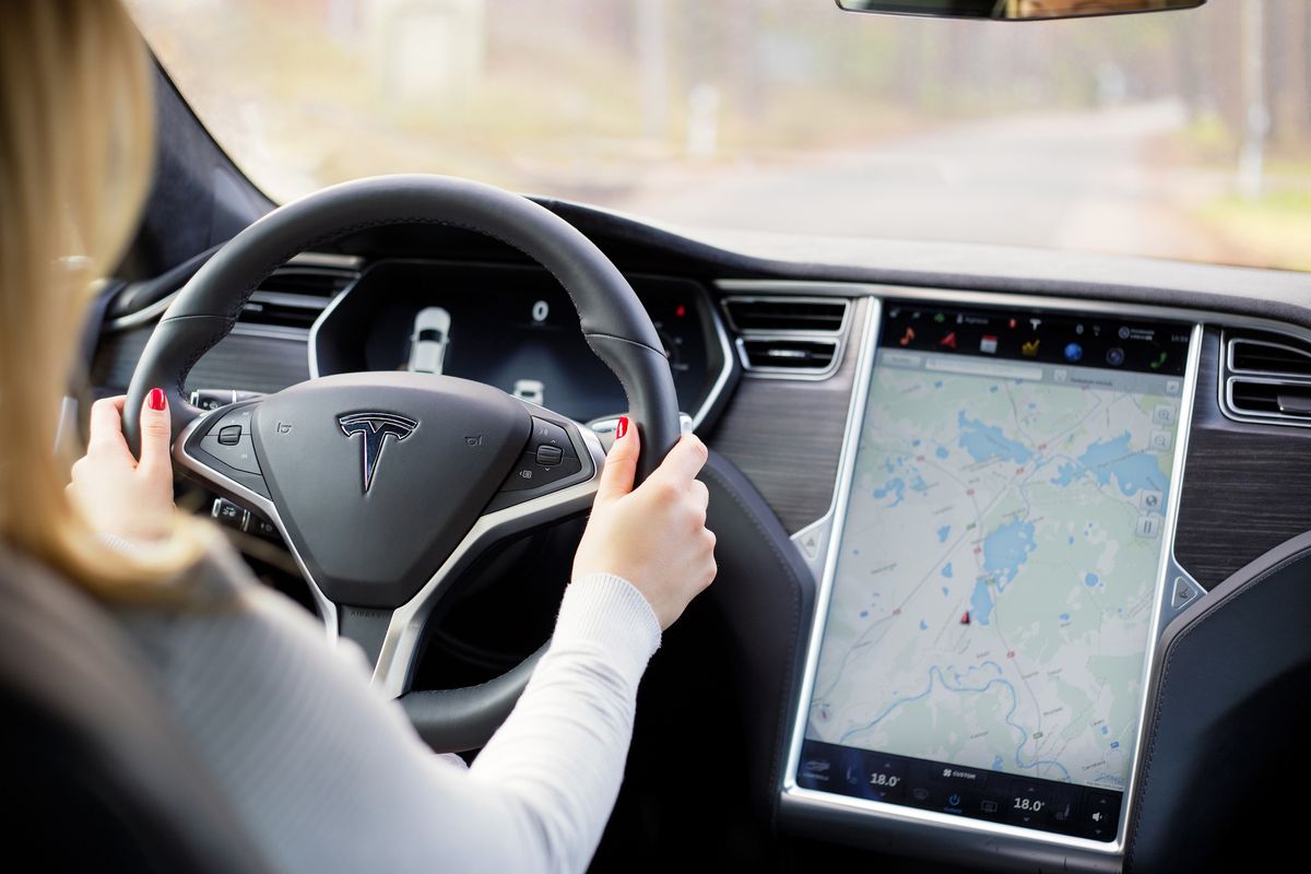 Woman driving Tesla Model S electric car