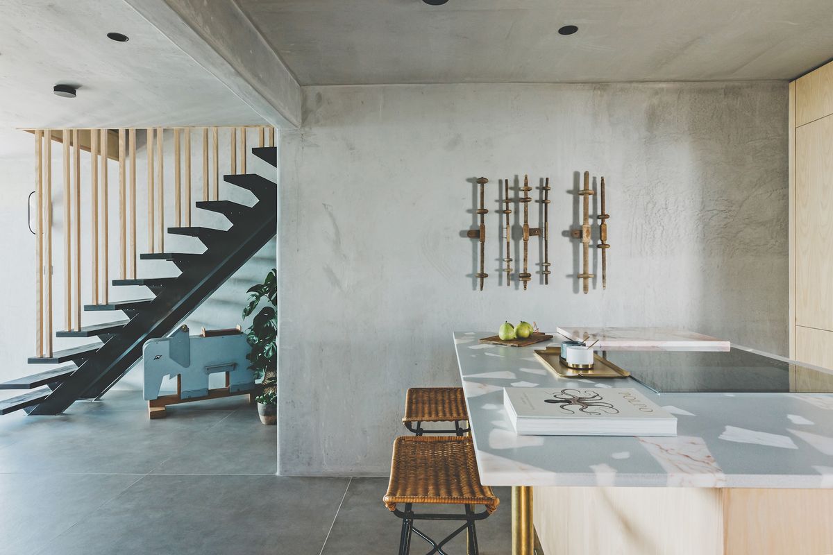 staircase and modern kitchen with concrete wall finish