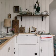 kitchen room with white wall and counter and white sink