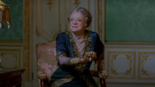 Dame Maggie Smith sitting in the drawing room in Downton Abbey A New Era.