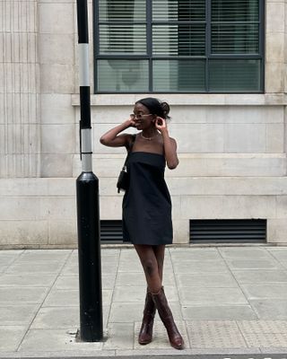 Classic outfits 2024: @livmadeline wears a black mini dress with tall boots