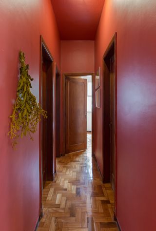 A narrow hallway painted in bright pink paint