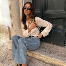 @fakerstrom outfit picture sitting in doorway in white button down and jeans