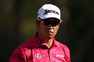 Hideki Matsuyama at The Players Championship wearing a bright pink polo and a white cap