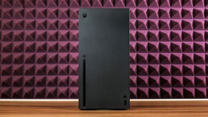 Xbox Series X console on table with purple sound proofing in background