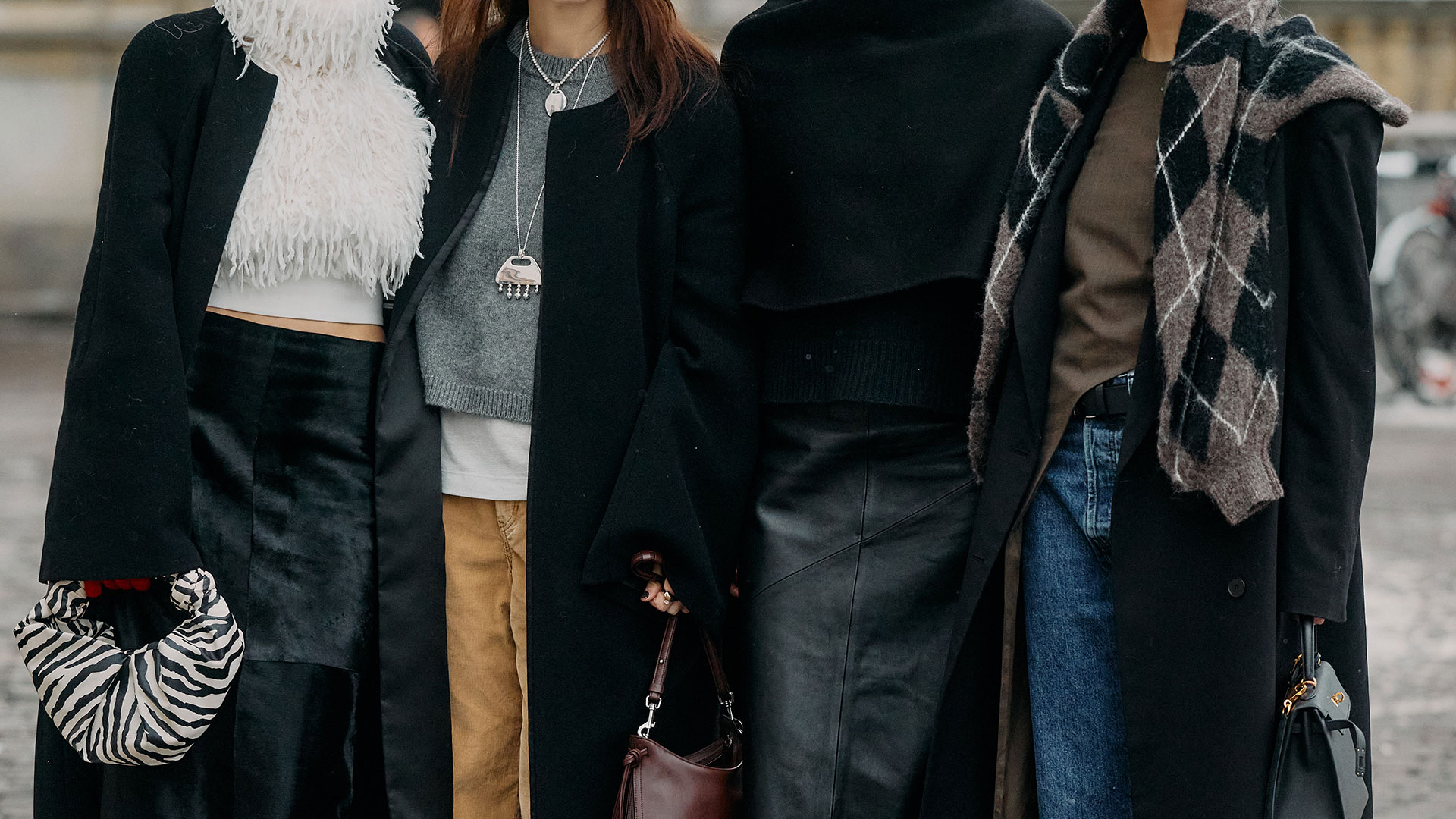 Copenhagen Fashion Week street style of four women in black and neutral outfits. 