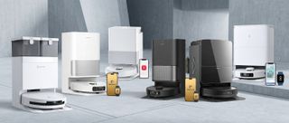 Several robot vacuums and docking stations in a concrete room