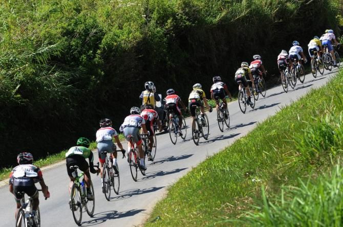 The peloton speed by on Stage 5 at the Tour de Singkarak