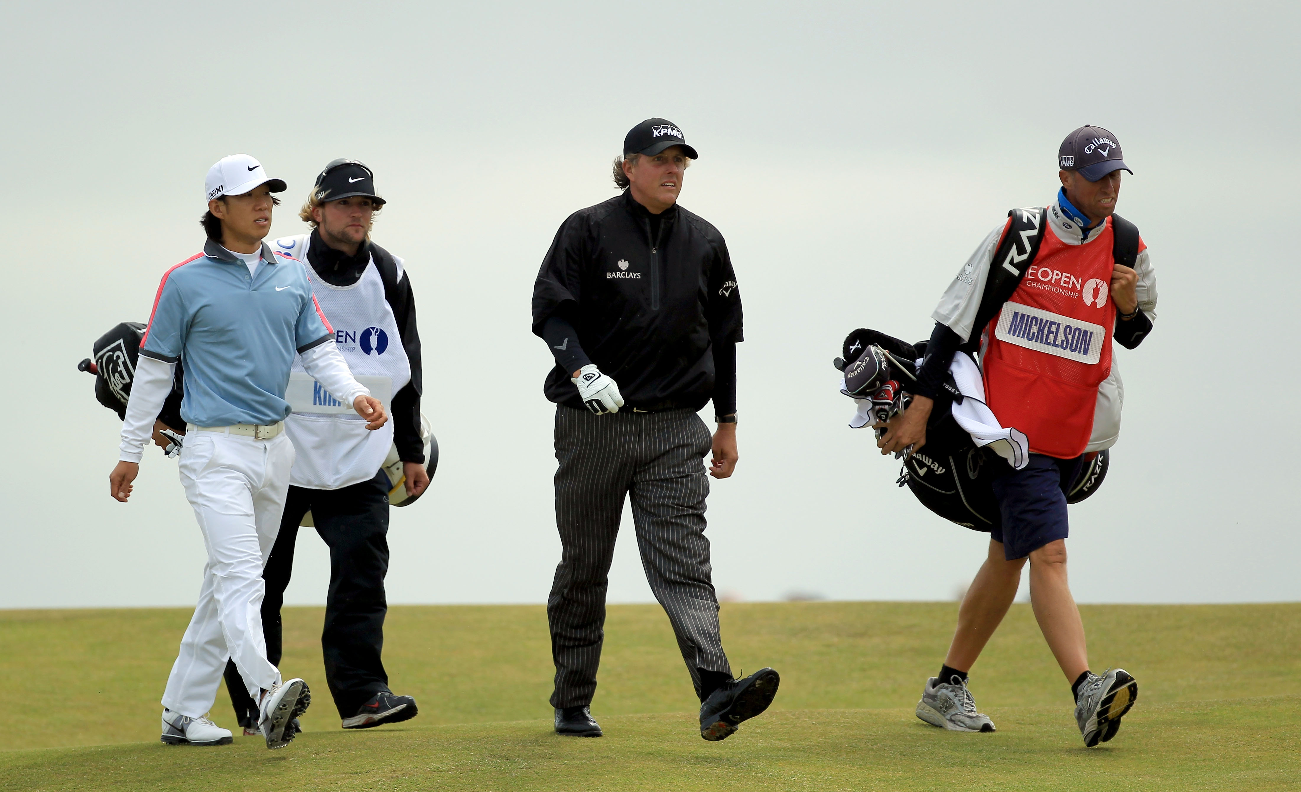 Anthony Kim (left) and Phil Mickelson walking along during the 2011 Open Championship