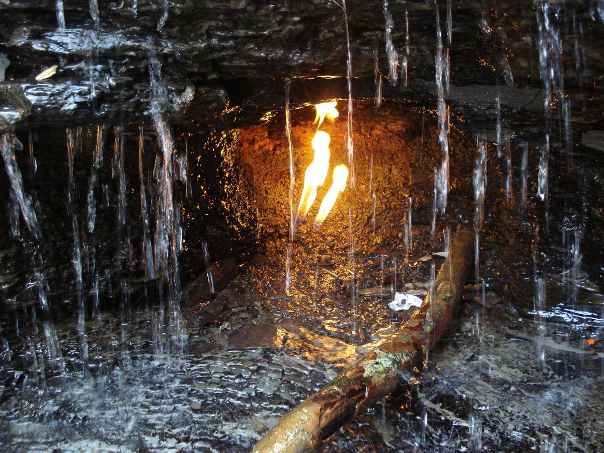 A gas-fired flame shines through a waterfall at Chestnut Ridge Park in Erie County, N.Y.