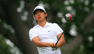 Anthony Kim watches a tee shot with a driver