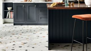 terrazzo effect porcelain floor tiles in a navy blue kitchen