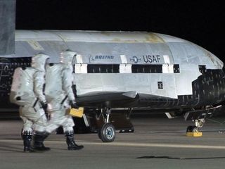 An Air Force X-37B robotic space plane is shown after it has landed at Vandenberg Air Force Base in California. The fourth mission of the program is now underway and nearing a year in Earth orbit.