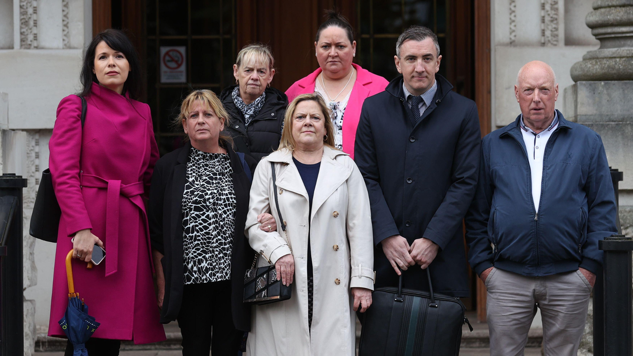 Relatives of people killed during the Troubles stand outside Belfast&#039;s High Court 