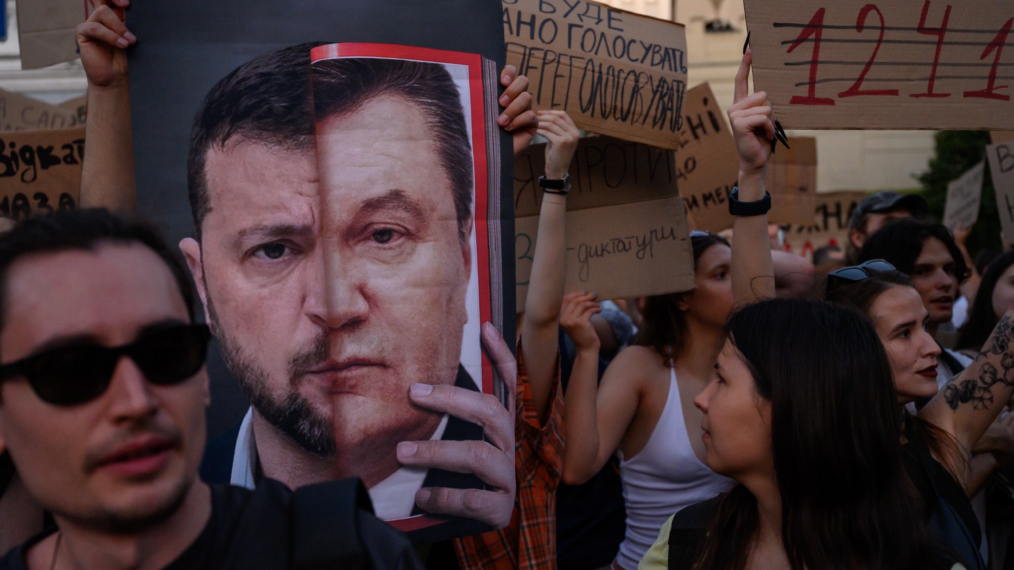 Protesters hold a poster of Volodymyr Zelenskyy at a protest against a new bill curtailing anti-corruption agencies in Kyiv