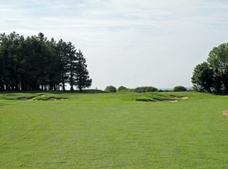 A necklace of bunkers protects the eighth