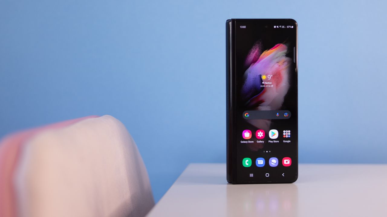 A photograph of the Samsung Galaxy Z Fold 3 folded over and stood on a table