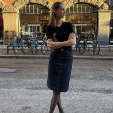 Amalie Moosgaard wearing a knee-length skirt and sheer tights. 