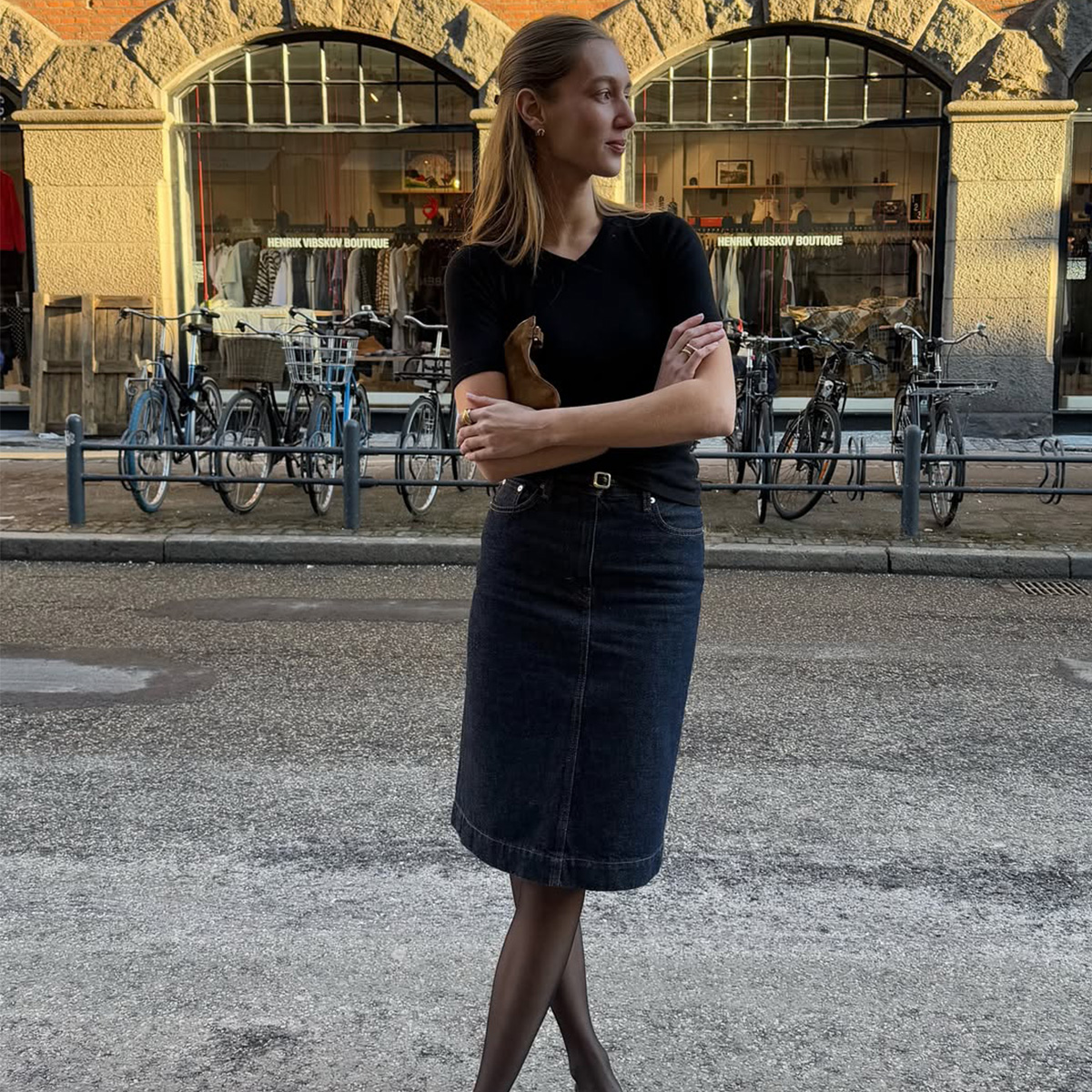 Amalie Moosgaard wearing a knee-length skirt and sheer tights. 