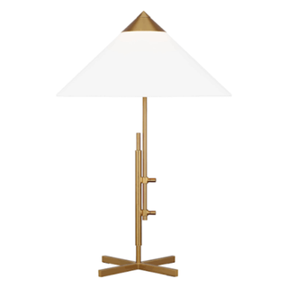 A brass table lamp with white triangular shade