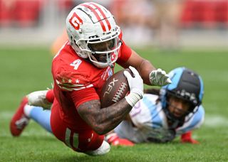 D.C. Defenders running back Abram Smith #4, dives for a 2nd half 1st down during the DC Defenders defeat of the Arlington Renegades 28-26 in XFL football on April 16, 2023