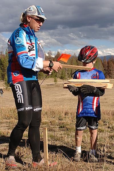 Coach Erik shows Aaron how to set up stakes and flags.