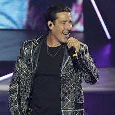 Jonathan Knight of New Kids on the Block singing into a microphone