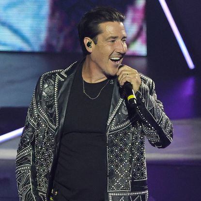 Jonathan Knight of New Kids on the Block singing into a microphone