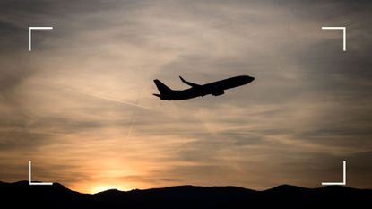 A commercial plane takes off after sunset from Geneva Airport in Geneva