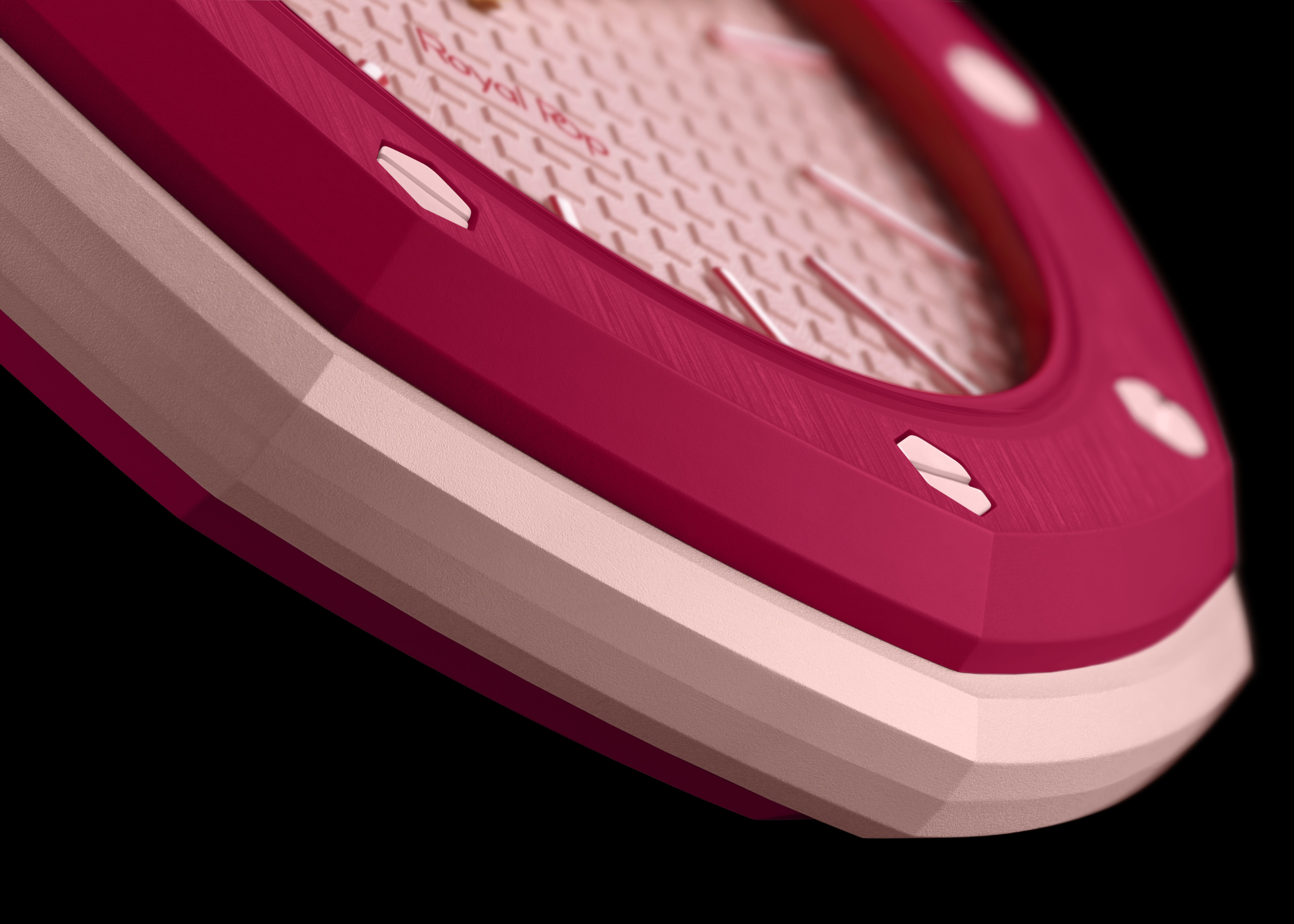 A detailed close-up shot focuses on the textured pink dial and dark pink octagonal bezel with exposed screws of a "Royal Pop" watch.