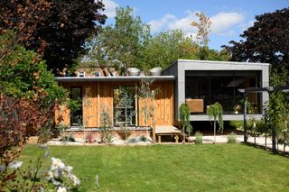 A tiny home with timber and metal cladding in a garden