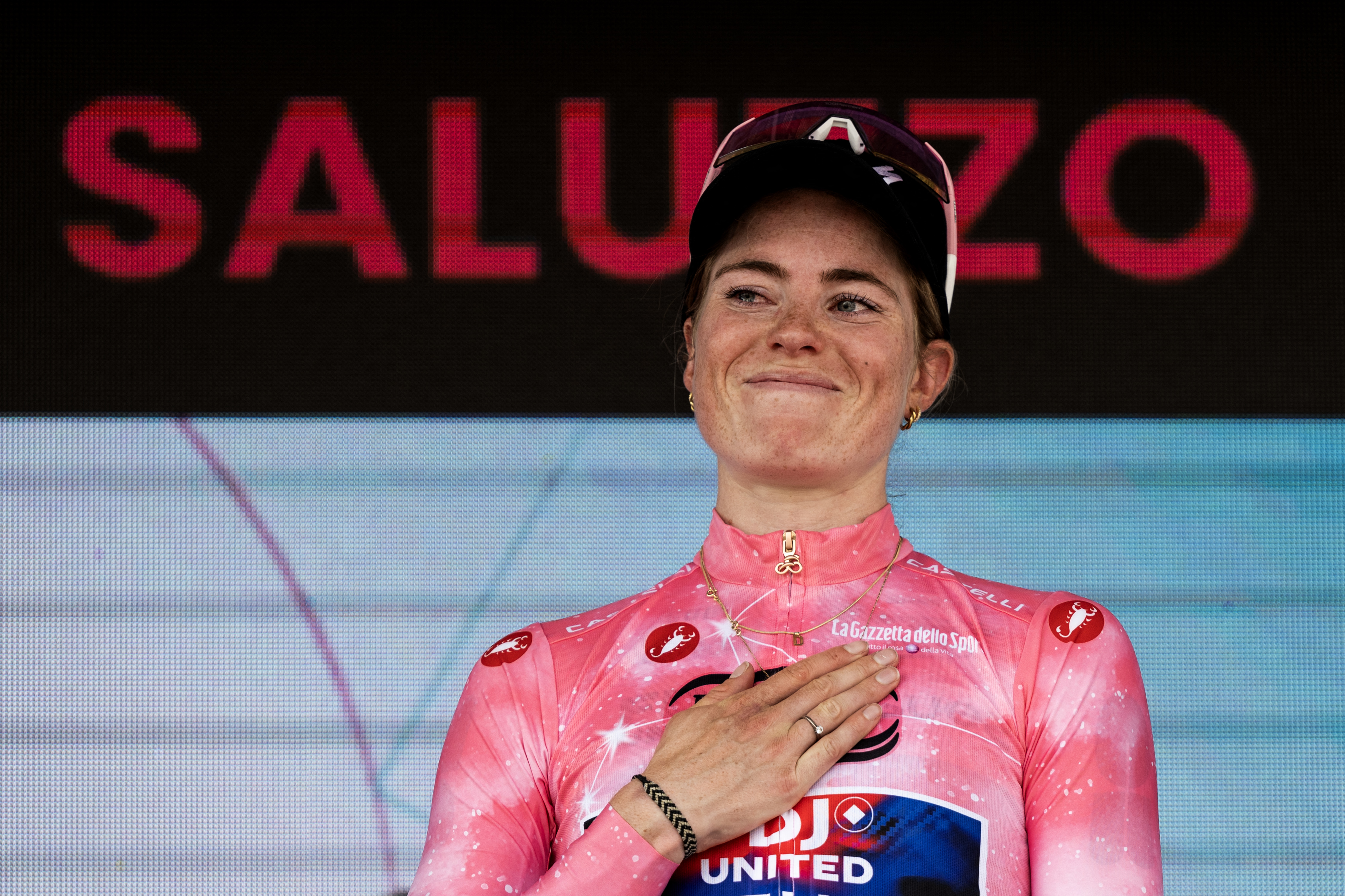 FDJ SUEZ Dutch rider Demi Vollering wearing the overall leader's pink jersey holds the trophy as she celebrates on the podium after winning the Giro d'Italia Women 2026 - Tour of Italy Women cycling race in Saluzzo, Northwestern Italy, on June 7, 2026. (Photo by MARCO BERTORELLO / AFP via Getty Images)