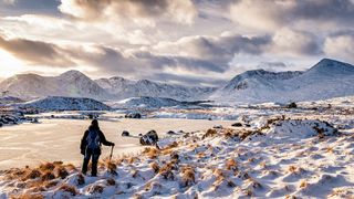 A lone walker in scotland's winter mountains