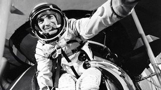 black and white photo of a smiling man in a spacesuit