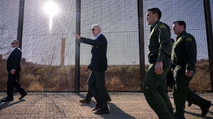 President Joe Biden walks along the US-Mexico border fence in El Paso, Texas
