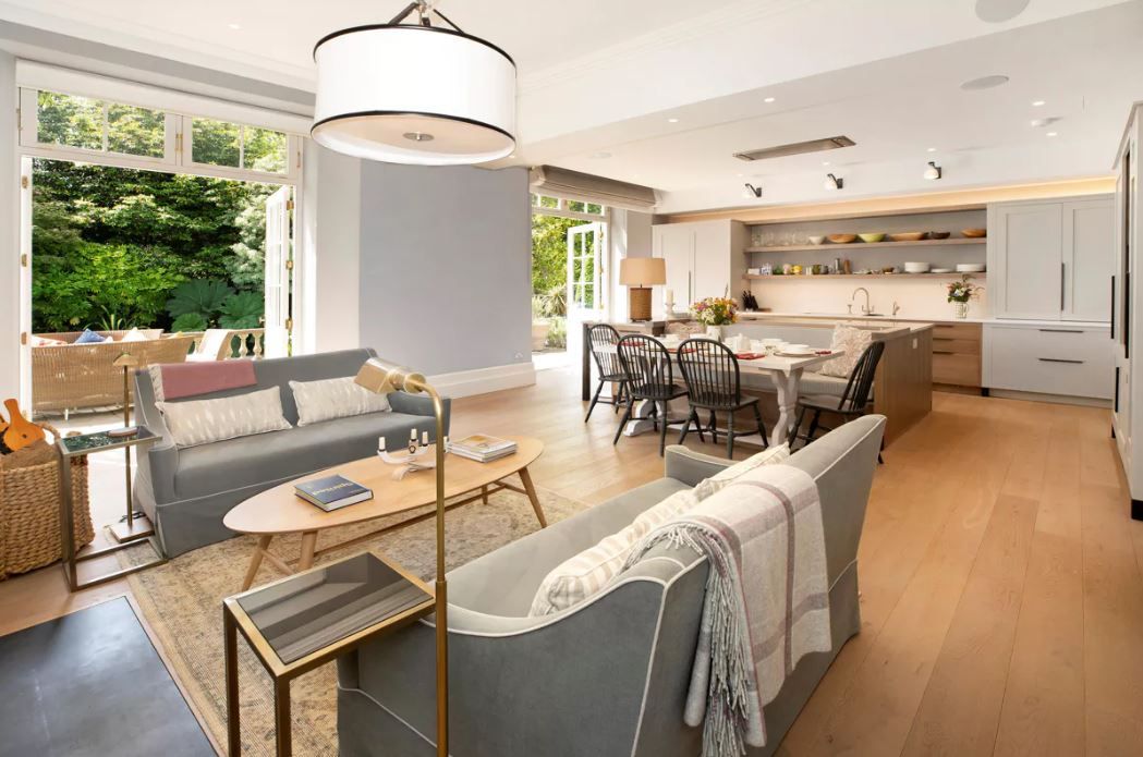 the kitchen dining room space with seating area to the front and kitchen cabinets and counters behind