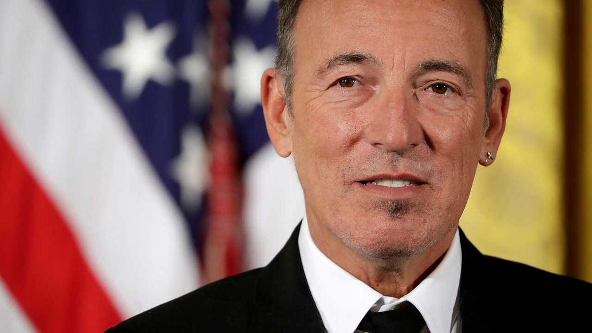 Bruce Springsteen pictured in front of a US flag at the White House in 2016 