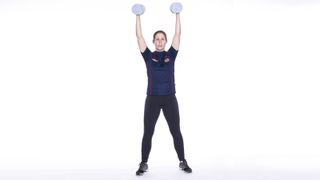 Woman doing a double shoulder press as part of a dumbbell arms workout