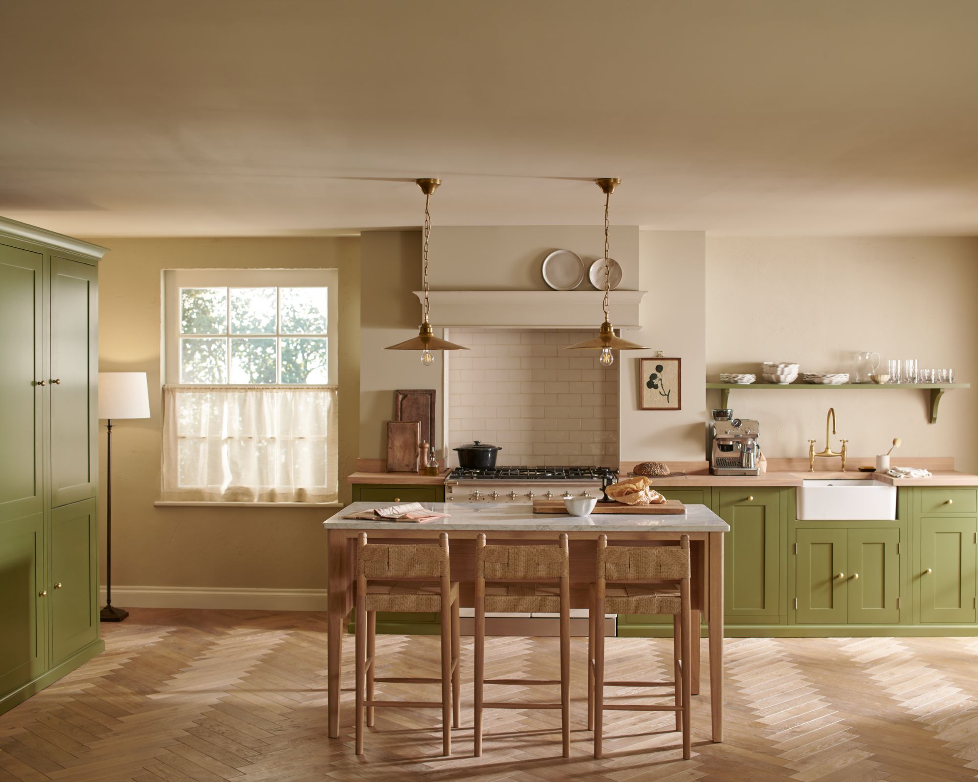A green kitchen with freestanding table
