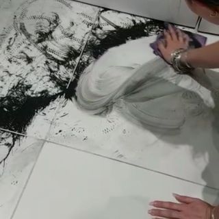 cleaning black spilled paint with cleaning cloth